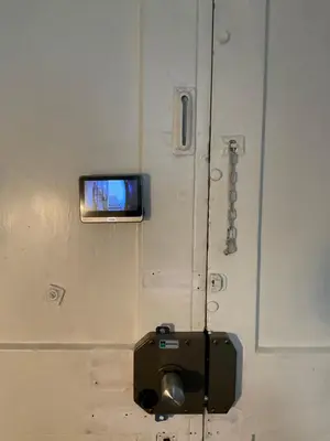 a tv on the wall of a room with a door at CoolStayPigneto in Rome