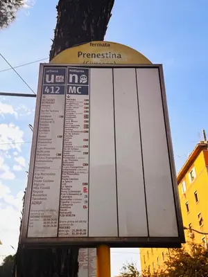 a sign on a pole next to a tree at CoolStayPigneto in Rome
