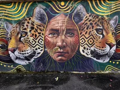 a mural of a woman with two jaguars at CoolStayPigneto in Rome