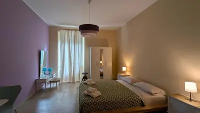 a bedroom with a bed and a large window at Appartamento C9 in Rome
