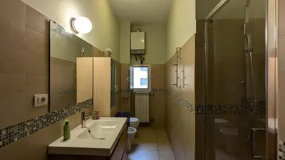 a bathroom with a sink and a shower and a toilet at Appartamento C9 in Rome