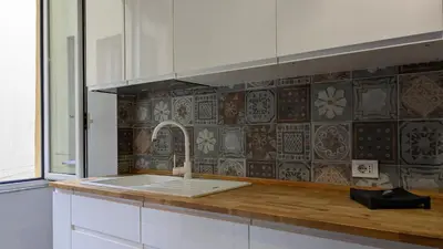 a kitchen with a sink and a tile wall at Appartamento C9 in Rome