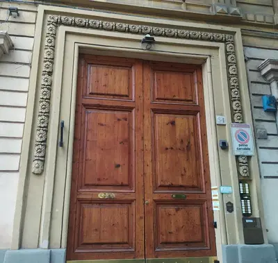 a large wooden door on the side of a building at Appartamento C9 in Rome