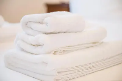 a stack of white towels sitting on a counter at Casa Geco Cozy apartment near St Peter in Rome