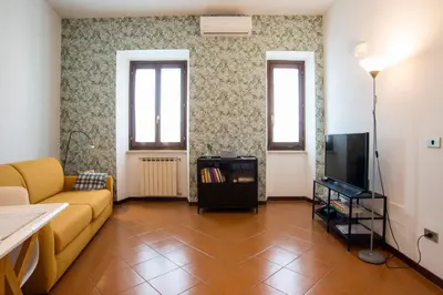 a kitchen with a white refrigerator and a sink at Casa Geco Cozy apartment near St Peter in Rome