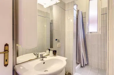a white bathroom with a sink and a mirror at Casa Dolce Casa in Rome