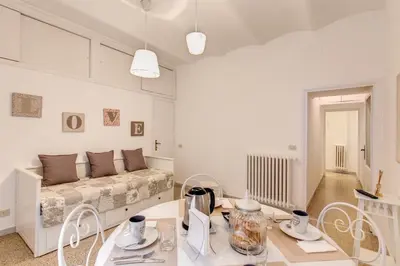 a living room with a bed and a table and chairs at Casa Dolce Casa in Rome