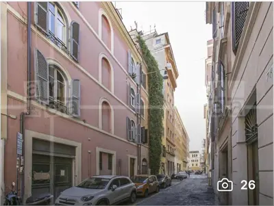 two cars parked on a street between two buildings at Casa Dolce Casa in Rome