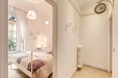 a bedroom with a bed and a clock on the wall at Casa Dolce Casa in Rome