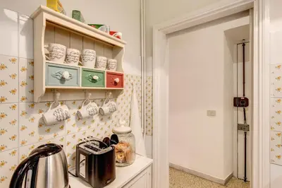 a kitchen with a counter with cups on the wall at Casa Dolce Casa in Rome