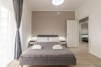 a bedroom with a bed with two towels on it at Domus 124, elegant city Comfort with Parking in Rome