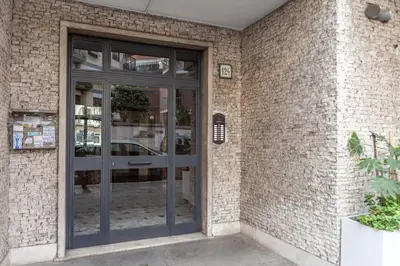 a glass door of a brick building at Domus 124, elegant city Comfort with Parking in Rome