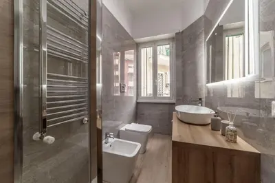 a bathroom with a toilet and a sink and a tub at Domus 124, elegant city Comfort with Parking in Rome