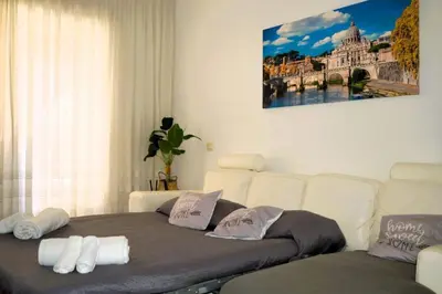 a living room with a couch and a bed at Fem House in Rome