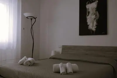 a bedroom with two beds with towels on them at Fem House in Rome
