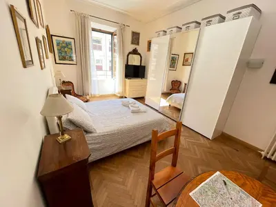 a bedroom with a bed and a mirror at Camera matrimoniale Roma Centro Vaticano in Rome