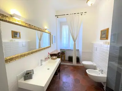 a bathroom with a sink and a toilet and a mirror at Camera matrimoniale Roma Centro Vaticano in Rome