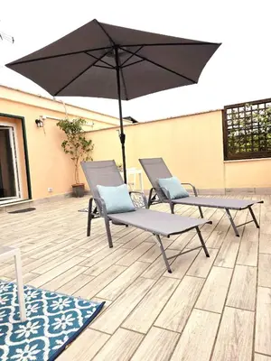 two chairs and an umbrella on a patio at Monteverde Rhome in Rome