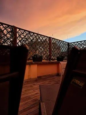 a balcony with a fence and a table with pots on it at Monteverde Rhome in Rome