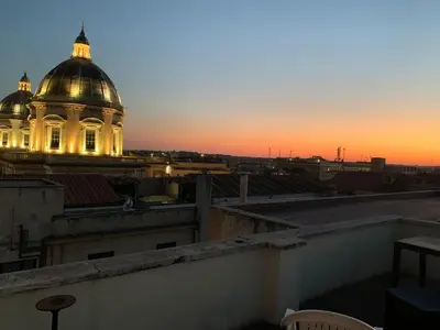 a building with a dome on top of a roof at G&A Rome House in Rome