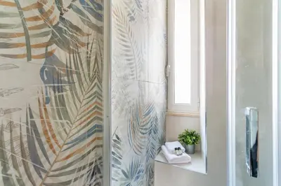 a bathroom with a shower curtain and a sink at iFlat Radiant retreat in Esquilino in Rome