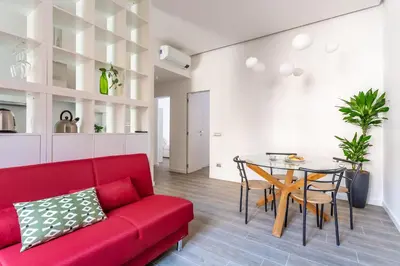 a living room with a red couch and a table at iFlat Radiant retreat in Esquilino in Rome