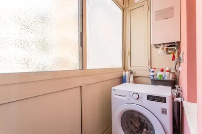 a washing machine in a bathroom with a window at iFlat Radiant retreat in Esquilino in Rome