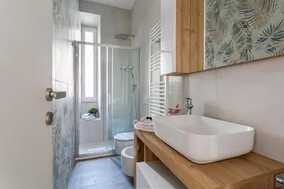 a bathroom with a large white sink and a toilet at iFlat Radiant retreat in Esquilino in Rome