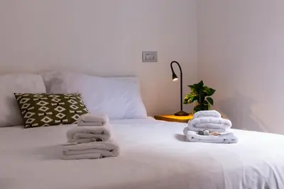 a pile of towels sitting on top of a bed at iFlat Radiant retreat in Esquilino in Rome