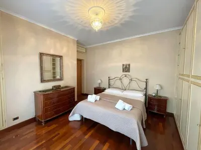 a bedroom with a bed and a dresser and a mirror at Domus St Peter in Rome
