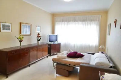 a living room with a bed and a television at Domus St Peter in Rome