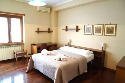 a bedroom with a bed with towels on it at Domus St Peter in Rome