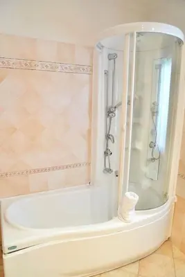 a white bath tub with a shower in a bathroom at Domus St Peter in Rome