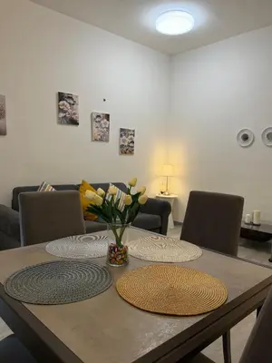 a living room with a dining room table and a television at La Casa di Aimara in Rome