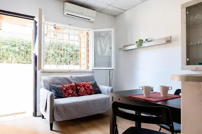 a living room with a couch and a table at Montagnola Mini House in Rome