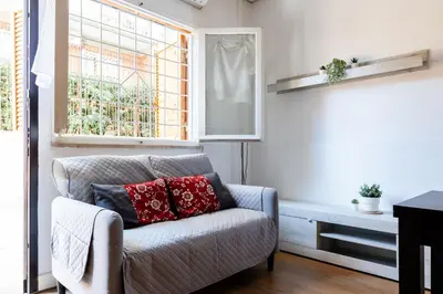 a living room with a couch and a window at Montagnola Mini House in Rome
