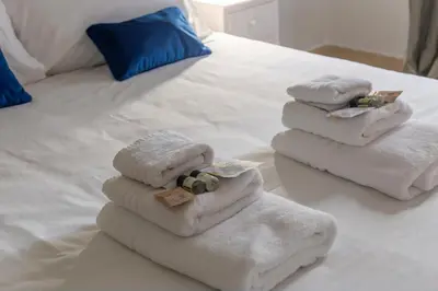 a pile of towels sitting on top of a bed at iFlat Colosseum's Brand New & Cozy Nest in Rome