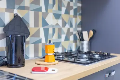 a kitchen counter top with a stove and a stove top at Amora Apartments in Rome