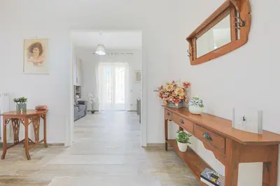 a living room with a wooden dresser and a mirror at Amora Apartments in Rome