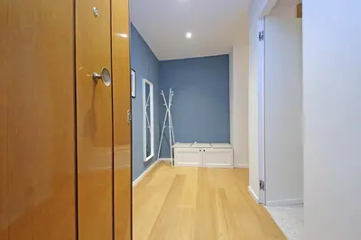 a room with blue walls and a wooden door at Modern Family Apartment in Rome