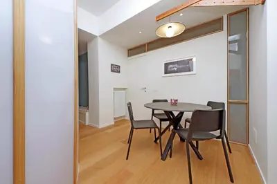 a dining room with a table and chairs at Modern Family Apartment in Rome