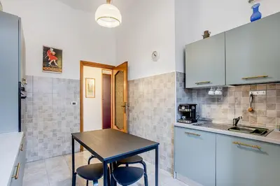 a kitchen with a table and chairs in a room at La Casa Viola in Rome