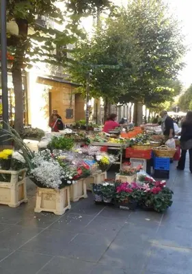 a flower market with flowers on a sidewalk at La Casa Viola in Rome