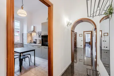 a kitchen with a table and a dining room at La Casa Viola in Rome