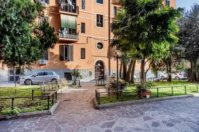 a building with benches in front of a building at La Casa Viola in Rome