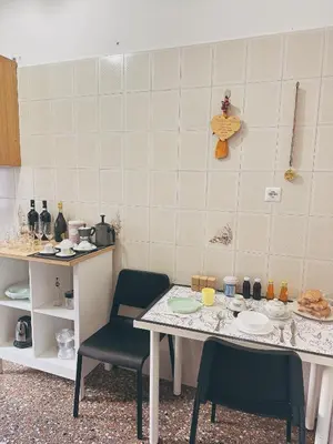 a kitchen with a table and two chairs at Betty House Roma in Rome