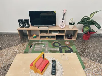a living room with a desk with a television and a table at Betty House Roma in Rome