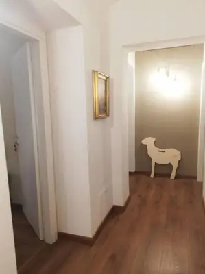 a hallway with a white room with a white horse on the wall at Epic Home in Rome