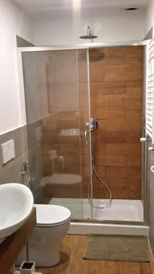 a bathroom with a shower with a toilet and a sink at Epic Home in Rome