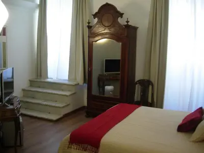 a bedroom with a bed and a mirror and a clock at Epic Home in Rome